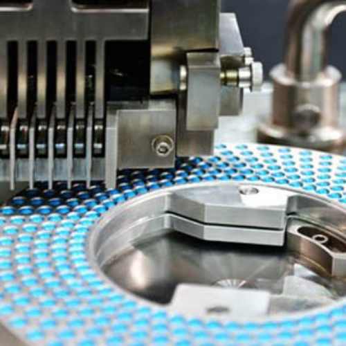 Shop Page Drug Manufacturing Blue capsule medicine pill production line, Industrial pharmaceutical concept.